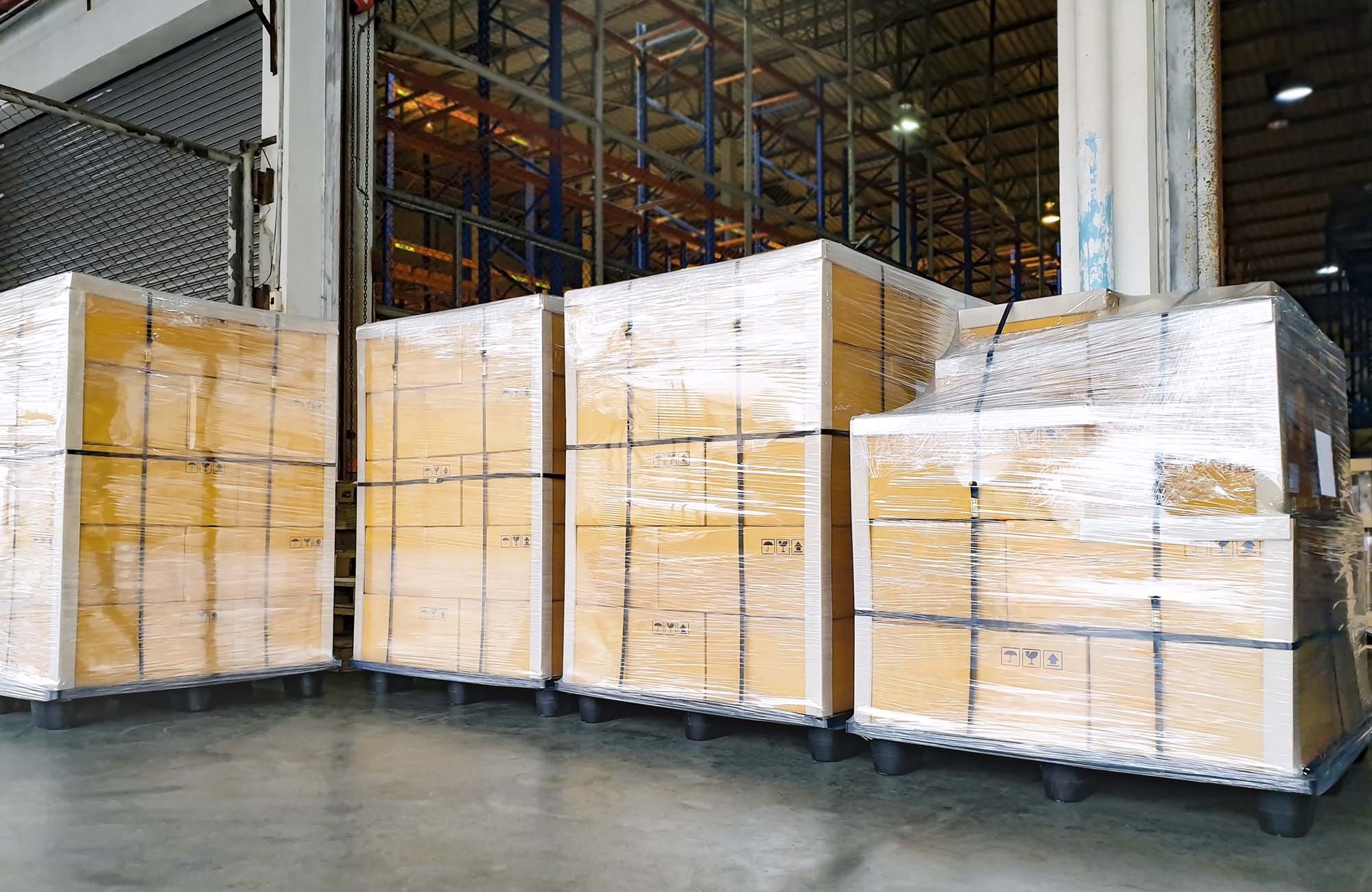 Large pallet goods,stack cardboard boxes wrapping plastic on pallets for export shipment, warehouse industry logistics, cargo transport